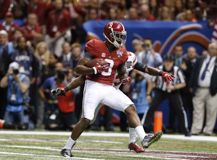 Jan 1, 2015; New Orleans, LA, USA; Alabama Crimson Tide receiver Amari Cooper (9) scores a touchdown in the fourth quarter against Ohio State Buckeyes cornerback Eli Apple (13) in the 2015 Sugar Bowl at Mercedes-Benz Superdome.